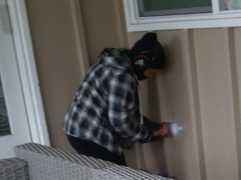 Professional electrician installing an exterior outlet in Tiger Point