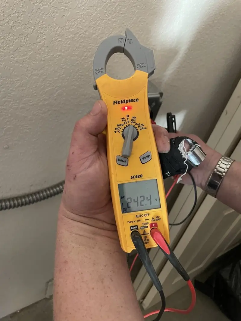 Voltage testing with clamp meter during Outlet Installation in Tiger Point